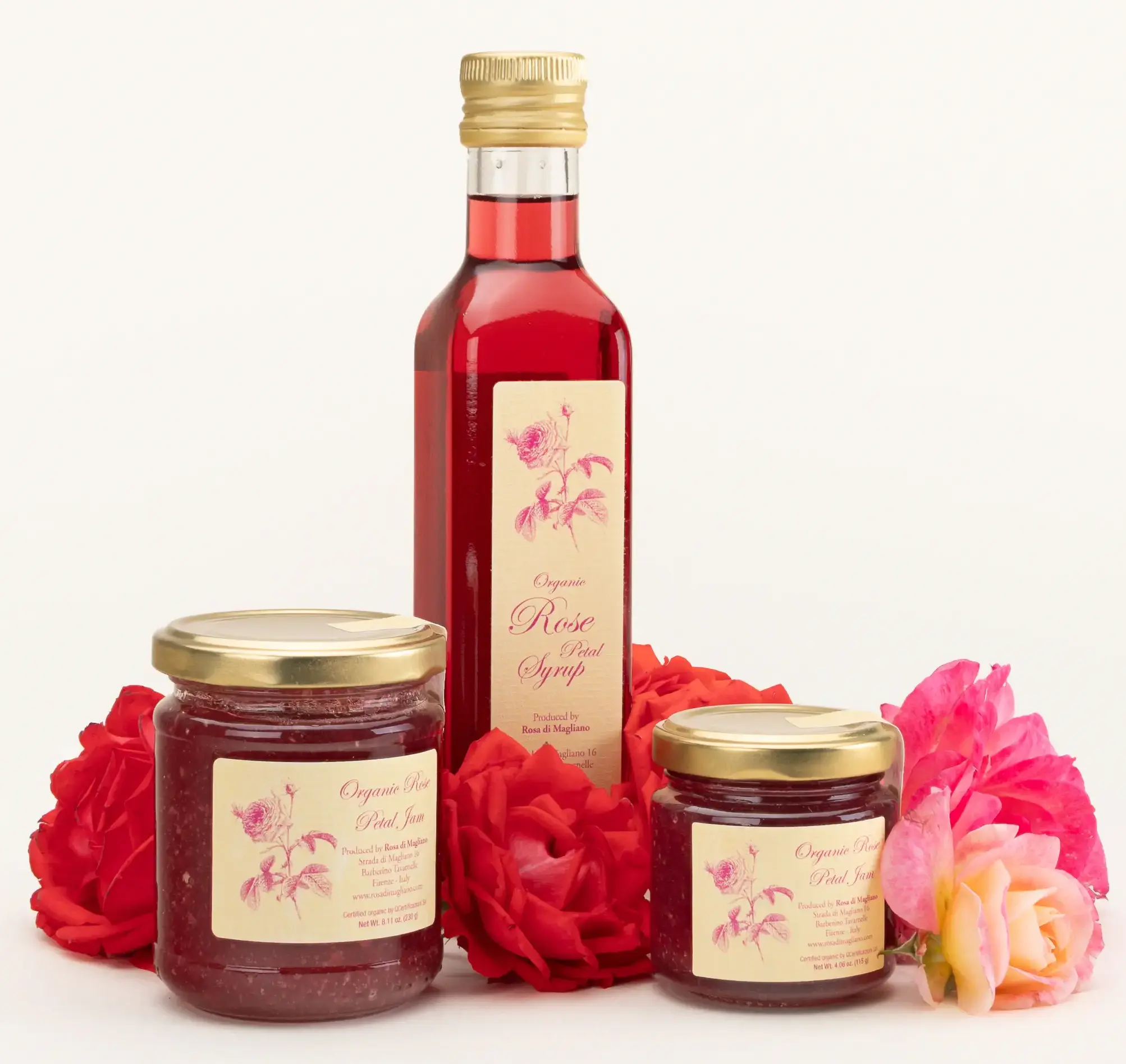 Rosa di Magliano organic rose petal syrup and two jars of rose petal jam among fresh roses